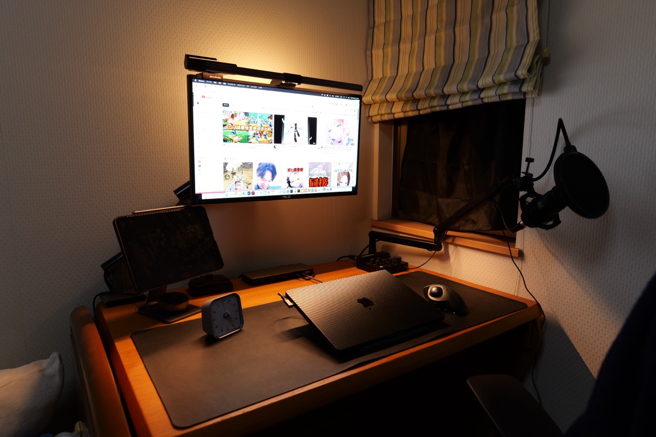 モニターライトの暖色の光でデスクの雰囲気作りをしている写真